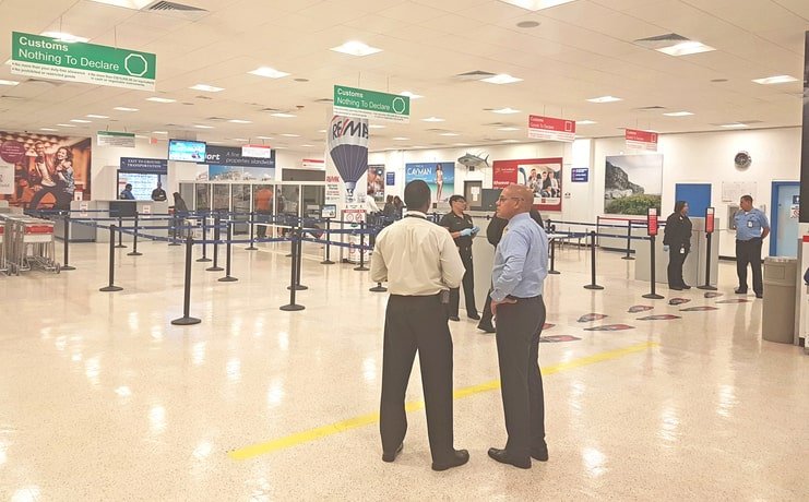 picture of officers standing in cayman airport customs area